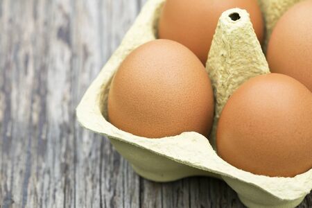 Close-up of fresh eggs on a wooden table with copy space