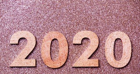 Glitter textured pink party web banner, background of 2020 numbers, happy new year with copy space