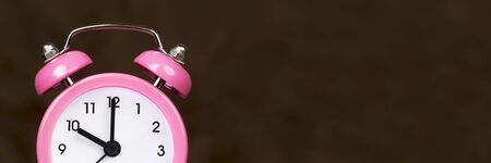 Manage time concept, alarm clock details on brown background, web banner with copy spaceの写真素材