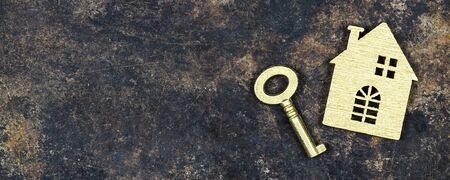 Buying, selling or renting home, apartment concept, house shape and gold key, web banner with copy spaceの写真素材