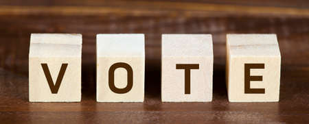Wooden cubes with vote text. Presidental US 2020 election, voting concept. Web banner.