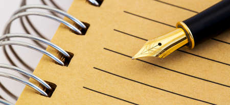 Vintage old gold fountain pen on paper. Grafology, calligraphy concept, web banner.の写真素材