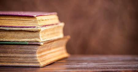 Old vintage books on the table, back to school banner with copy spaceの写真素材