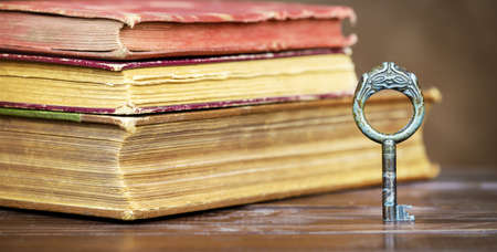 Story book, storytelling banner, old books and key on the tableの写真素材