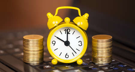 Alarm clock and gold money coins, financial planning bannerの写真素材