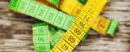 Web banner of a retro colorful tape measure. Weight loss concept.の写真素材