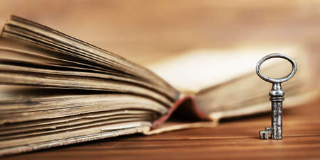 Vintage key with book. Motivation, solution, success. Life coaching banner.の写真素材