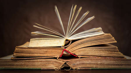Old antique vintage books on the table, back to school, learning, reading background