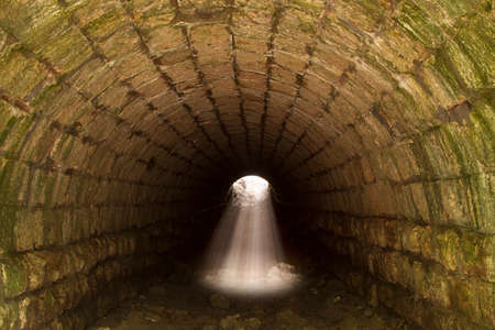 Light at the end of the tunnel. Out of body or near death experience, spirituality, hope, rebirth concept.の写真素材