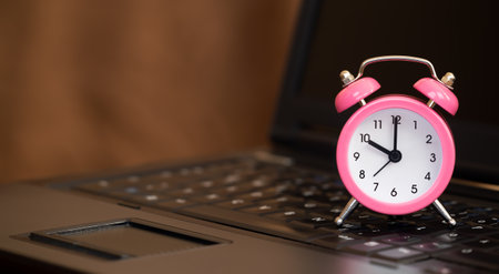 Alarm clock on the laptop. Save or manage time, daylight savings banner, background with copy space.