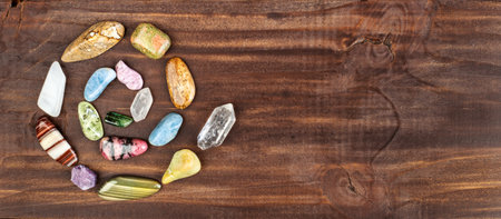 Colorful healing crystal stones, gemstones in happy spiral shape. Alternative therapy, chakra energy, reiki or spiritual banner.の写真素材