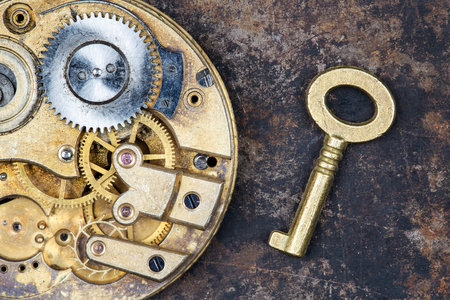 Gold vintage key with clockwork. Escape room game, winning background.
