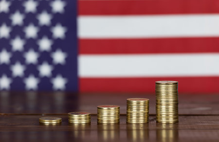 Growing gold coins with american flag in the background. Business success, USA investments.の写真素材