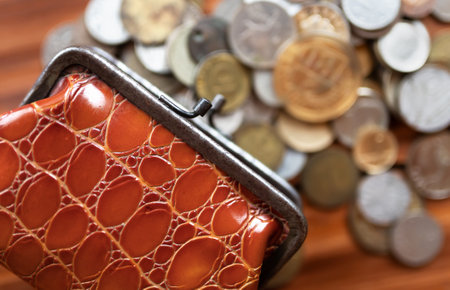 Old wallet with money coins. Inflation, home finances, budget concept.の写真素材
