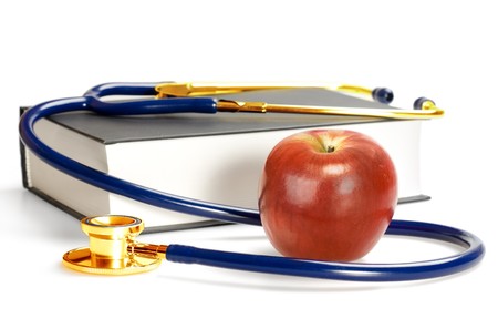 Stethoscope, book and appleの写真素材