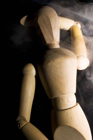 wooden mannequin in smokeの写真素材