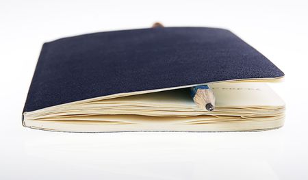 notebook and pensil on white (popular notebook with yellow paper)