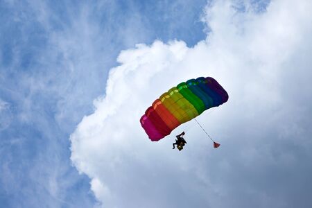 Skydiver flying in bright blue sky.の写真素材