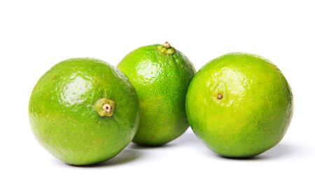 green limes isolated on whiteの写真素材
