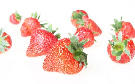sweet red strawberries isolated on a whiteの写真素材