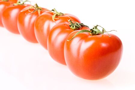 Tomatoes row isolated on white background.の写真素材