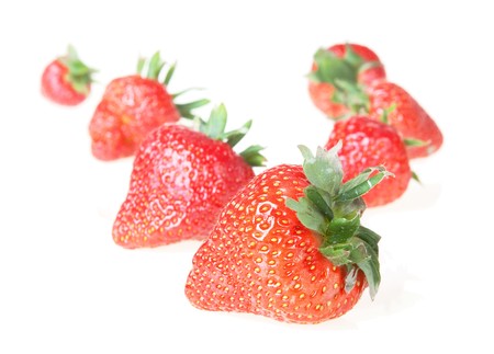 sweet red strawberries isolated on a whiteの写真素材