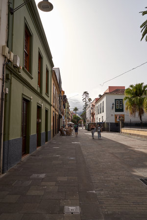 A narrow urban street lined with numerous buildingsのeditorial素材