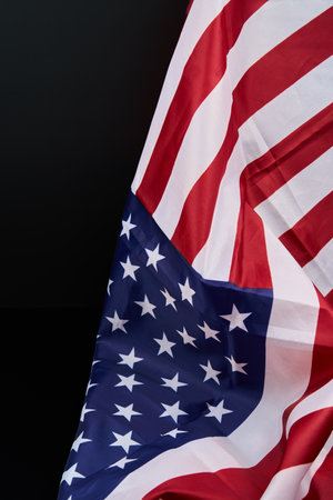 A detailed view of the American flag against a dark backdrop