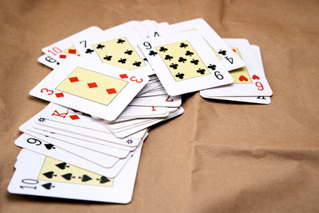 A deck of poker cards spread out on a table.