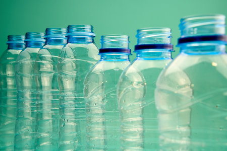 The beauty of environmental commitment, plastic bottles in a row on a green backgroundの写真素材