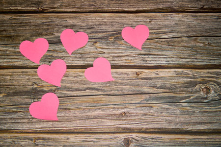 pink hearts on a rustic wooden tableの写真素材
