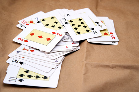 A deck of playing cards spread out on a table.