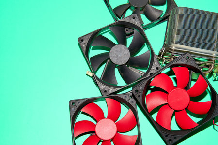 Cooling fans for computers, scattered on a green surfaceの写真素材