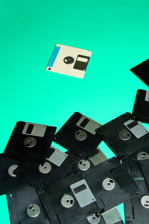 A set of floppy disks on a turquoise background.