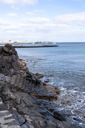 The rugged coastline of Lanzarote, showcasing dramatic volcanic rock formations and the ocean.