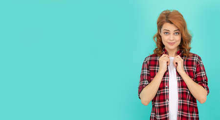happy redhead woman with curly hair in checkered casual shirt, copy space, trendの写真素材