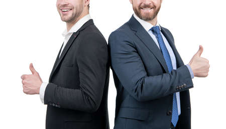 two cropped men back to back. businessmen in suit. boss and employee. confident business partners.の写真素材