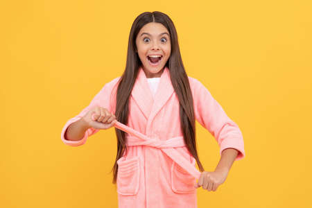 amazed teen girl in home terry bathrobe, homewearの写真素材