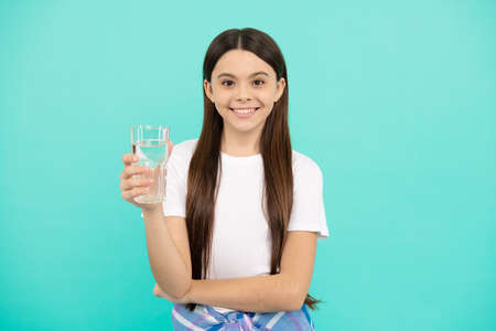 teen girl going to drink mineral beverage. healthy childhood lifestyle. water balance in body.の写真素材