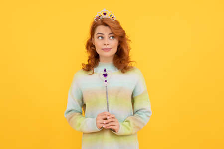 redhead woman in queen crown with magic wand, wishの写真素材