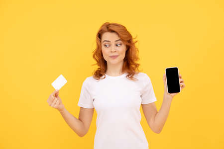 shopping from home. cyber monday. fast pc payment. amazed girl show smartphone.の写真素材