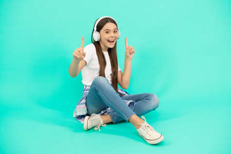 happy child girl listen to music in wireless headphones, device accessoryの写真素材