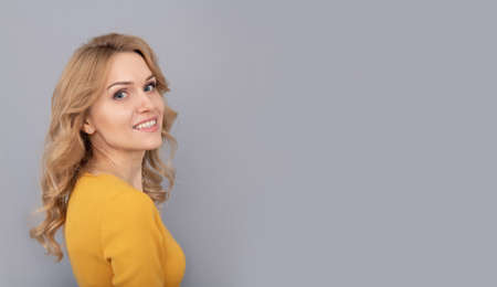 cheerful blonde beauty woman with curly hair, copy space, youthの写真素材