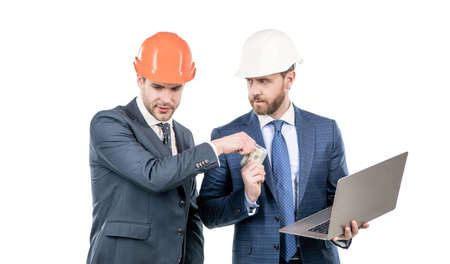 financial support. investment in architectural project. men businessmen with money and laptop.の写真素材