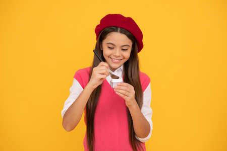 kid cosmetology. smiling child in beret use cosmetics. natural female skin beauty.の写真素材