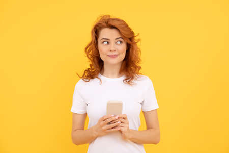 modern communication technology. dreamy redhead woman working online.の写真素材