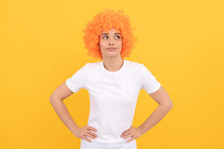 looking up. funny girl in orange wig. april fools day. happy lady having fun. going crazy.の写真素材
