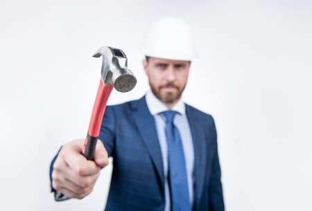 construction hammer tool and businessman isolated on white. safety business. hammer in handの写真素材
