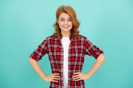happy redhead woman with curly hair in checkered casual shirt, styleの写真素材