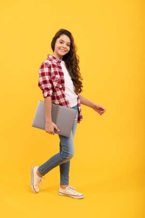 E-learning is a better way of learning. Happy girl child carry laptop. E-learning. Elearningの写真素材